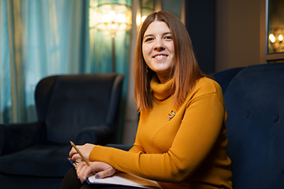 a therapist smiles as she considers addiction treatment therapies in co