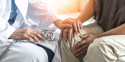 a doctor talks to a patient about an addiction treatment program involving medication assisted treatment program in co