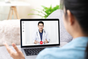 a patient talks to her doctor through a telehealth program