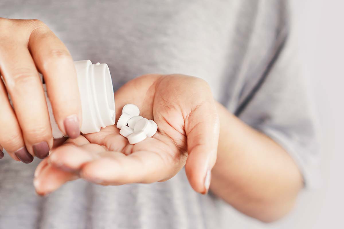 a person takes medication for heroin addiction