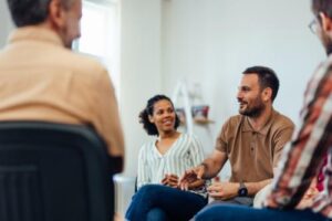 man talks with peers in an addiction treatment center in colorado